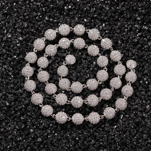 Macro view of iced-out ball chain necklace with white cubic zirconia and silver base