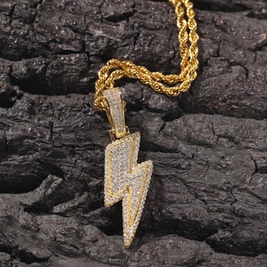 Detail of hip hop lightning pendant with micro-pave zircons on a gold rope chain