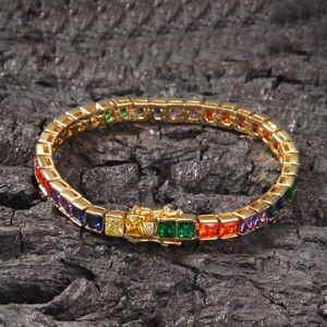 Detail shot of rainbow tennis bracelet with gold setting and colored cubic zirconia