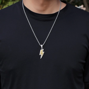 Close-up of hip-hop lightning bolt pendant with yellow and white micro-pave zircons