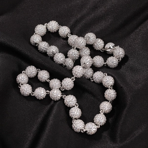 Detailed view of hip hop ball chain necklace with sparkling cubic zirconia on black silk