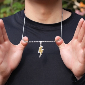 Close-up of hip hop lightning pendant with yellow and white zircons on rope chain