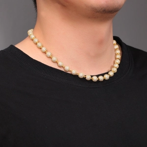 Close-up of hip-hop gold ball chain necklace with white zircon pavé on male model