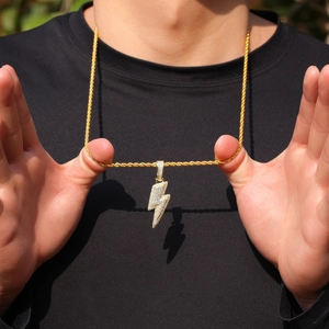 Detail of gold lightning bolt pendant with micro-pave cubic zirconia on a twist chain