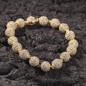 Detail of hip hop beaded bracelet with pave-set zircons on a dark textured background