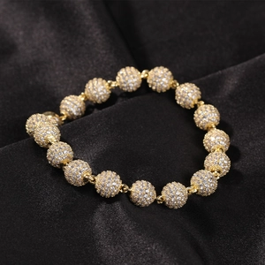 Macro view of gold micro-pave zircon beaded bracelet on a premium black silk backdrop