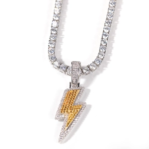 Macro shot of silver tennis chain with layered yellow and white lightning pendant