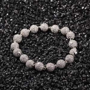 Hip hop bead bracelet with sparkling micro-pave zircons on a black rocky background