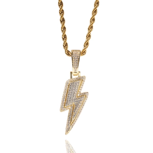 Close-up of golden lightning bolt pendant with pavé cubic zirconia on a rope chain