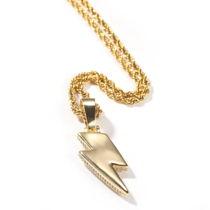 Macro side view of golden lightning pendant with cubic zirconia stones on rope chain