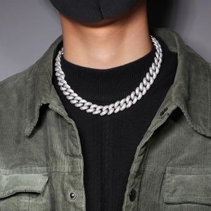 Detailansicht der silbernen Cuban-Link-Armband mit funkelndem Zirkonia am Handgelenk des Models