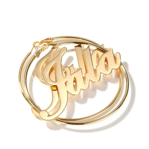 Detail of custom name gold hoop earrings featuring artistic Jalia lettering
