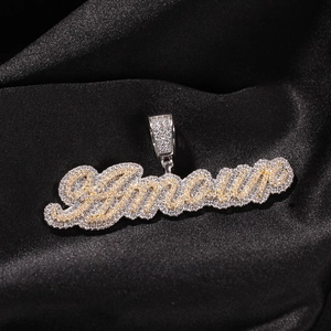 Detalle macro del colgante de letras Amour bicolor con circonitas incrustadas