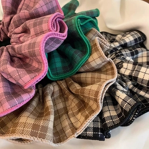 Macro detail of French retro plaid scrunchies showing fabric texture and elastic design