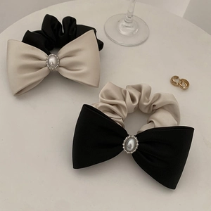 Elegant satin bow scrunchie set with pearl and rhinestone center on white background