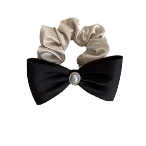 Elegant satin bow scrunchie in beige and black with a pearl and rhinestone center