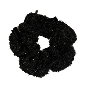 Sparkling black plush scrunchie with velvet bow details and metallic tinsel accents