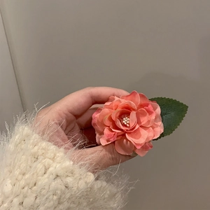 Pink vintage camellia hair clip with green leaves and pearl detail for women