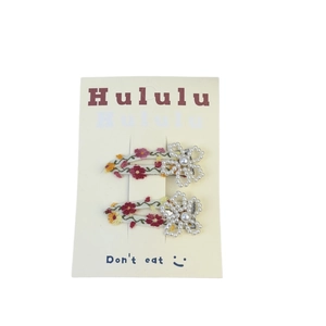 Floral embroidery hair clips set with artificial pearl accents on display card