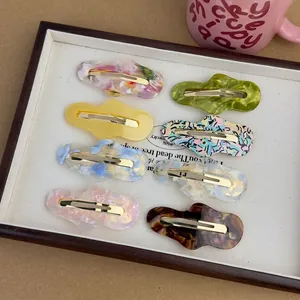 Set of 8 irregular cloud-shaped acetate hair clips in various colorful marble patterns