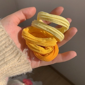 Détail d'élastiques à cheveux côtelés à haute élasticité en tons orange et jaune macaron