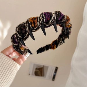 Close-up of multicolored knitted twist headband with non-slip inner teeth for hair grip
