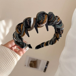 Close-up of knitted yarn headband with non-slip inner teeth and colorful mixed wool texture