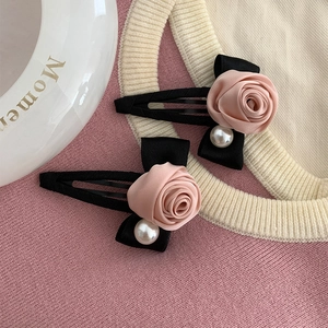 Elegant Korean style pink rose ribbon hair clips with faux pearls on pink knit background