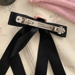Elegant black satin bow hair clip with pink fabric center and silver spring clasp