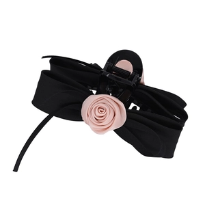 Elegant Korean style black ribbon bow hair clip with a pink fabric rose on white background