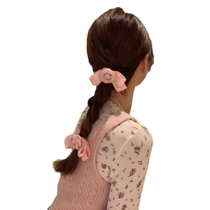 Elegant pink camellia fabric bow hair clip on low ponytail hairstyle for women