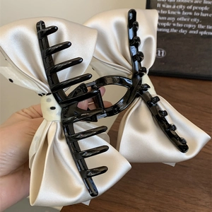 French vintage style cream bow hair claw clip with black polka dots for women
