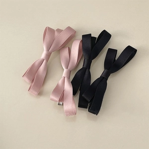 Pink and black satin bow hair clips with double-layered ribbons and silver duckbill clips