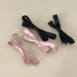 Set of four satin bow hair clips in black and dusty pink for elegant hairstyling