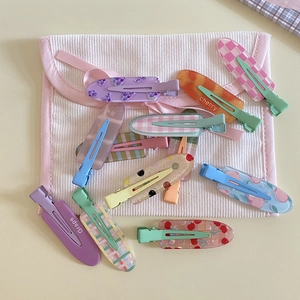 Cute fruit-themed hair clips set with cherry and grape designs and pink corduroy bag