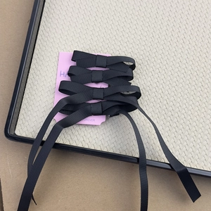 Set of five black ribbon bow hair clips on pink card for balletcore style