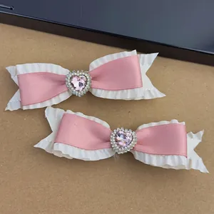 Pink and white satin bow hair clips with heart-shaped crystal and faux pearl accents