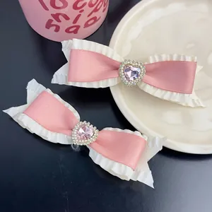 Sweet pink satin bow hair clips set with heart crystal and pearl details for women