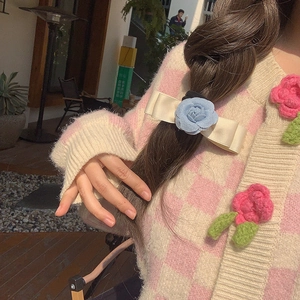 Blue camellia flower hair clip with cream satin bow accessory for elegant styling