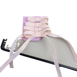Pink grosgrain ribbon bow hair clips set on display card for elegant styling