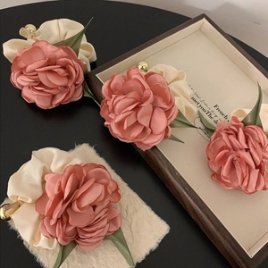 Pink satin rose flower scrunchie with green leaves and elegant golden charm detail