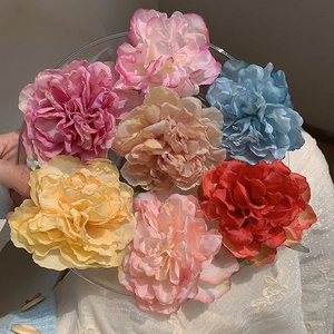 Peony hair clips set featuring seven colors like pink and blue in a hand-held tray