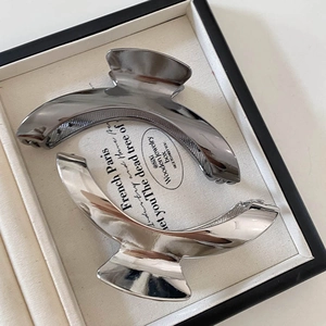 Minimalist arched metal hair claws in glossy silver and gunmetal black finishes