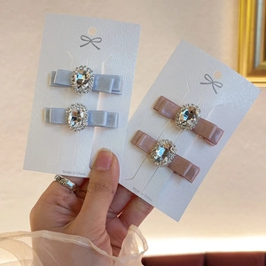 Elegant rhinestone bow hair clips in light blue and pink silk fabric for women