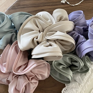Morandi colors satin silk scrunchies set with soft pleated texture on wood background