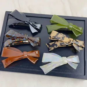 Handmade acetate bow hair clips in multiple colors like tortoiseshell and leopard print