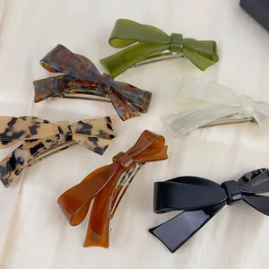 Set of six elegant acetate bow hair clips in olive, tortoiseshell, and neutral tones