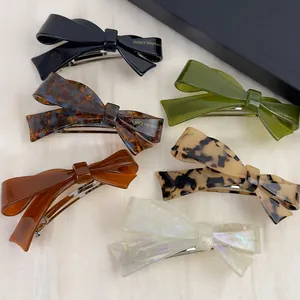 Elegant handmade acetate bow hair clips in six diverse marbled colors with spring clasps