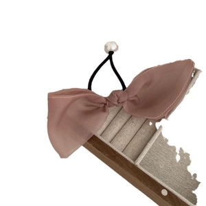 Eleganter Haargummi mit rosa Chiffonschleife und Elfenbeinperle auf schwarzem Gummiband