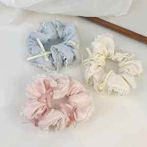 Set da 3 elastici in pizzo con fiocco e perla in blu, beige e rosa confetto